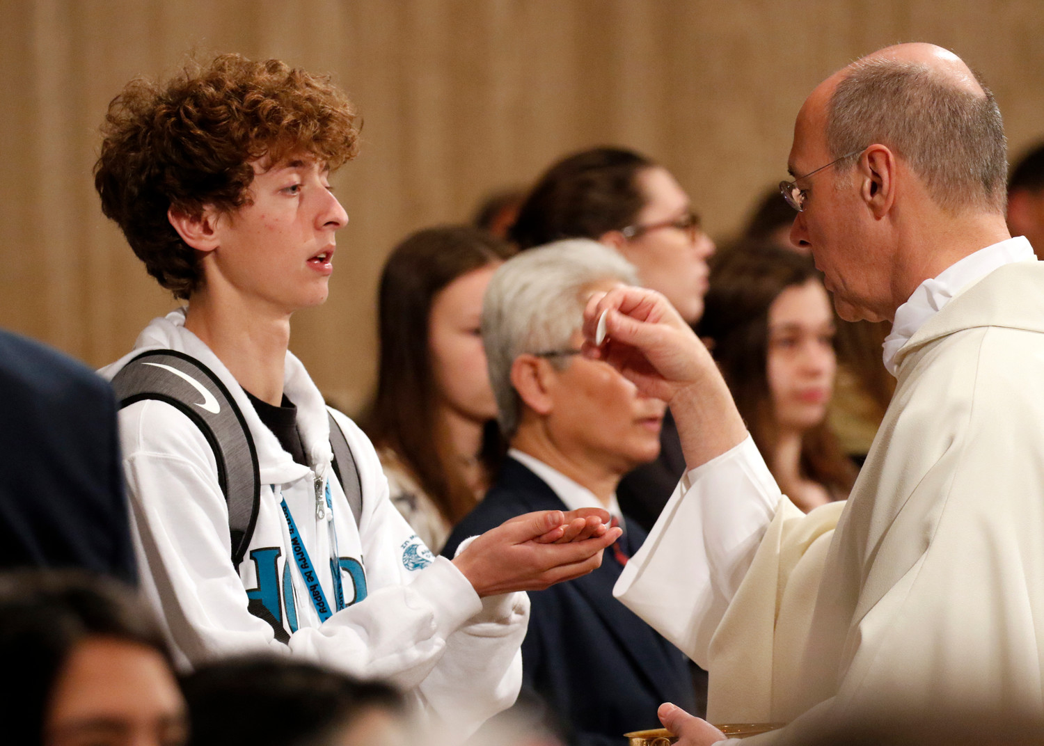 A young man receives Communion during the opening Mass of the National Prayer Vigil for Life Jan. 17 at the Basilica of the National Shrine of the Immaculate Conception in Washington.